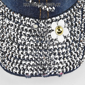 Denim baseball cap featuring a diamond-studded brim and a daisy flower accent