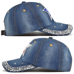 Detail view of denim baseball cap featuring sparkly rhinestones and pentagram patch