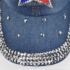 Macro detail of denim baseball cap brim with rows of silver rhinestones and star pattern