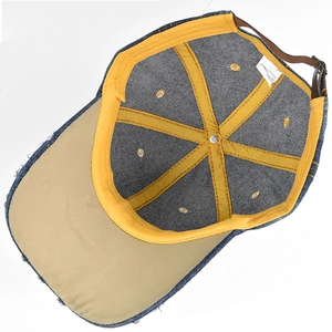 Internal view of denim baseball cap with yellow seam tape and 100% cotton label
