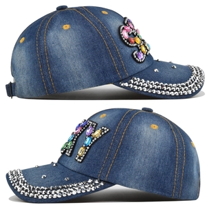 Detail view of denim baseball cap with crystal NY logo and colorful rhinestones
