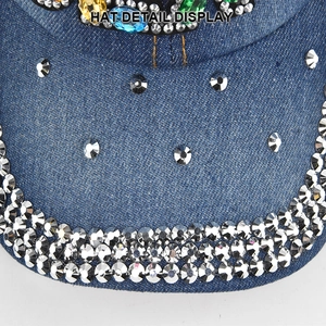 Macro shot of sparkling rhinestones and colorful crystals on blue denim baseball cap