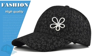 Close-up of black baseball cap featuring floral lace texture and rhinestone flower design