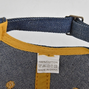 Detail view of the 100% cotton inner lining and metal buckle on the denim baseball cap