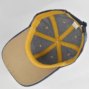 Detail of baseball cap interior showing 100% cotton label and yellow seam taping