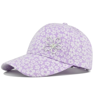 Close-up of floral baseball cap with purple fabric and sparkly rhinestone flower detail
