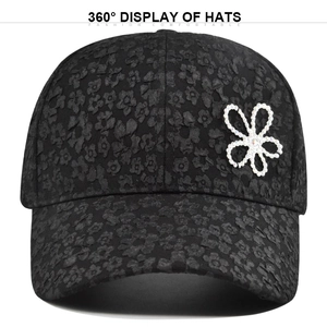 Close-up of black floral textured baseball cap with sparkling rhinestone flower detail