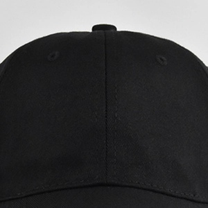Gros plan sur la casquette en coton noir montrant le sergé et les coutures renforcées