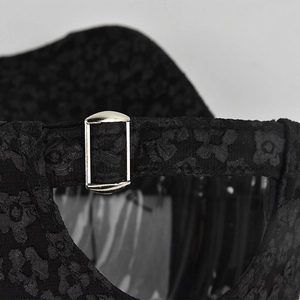 Rear view of black jacquard baseball cap with floral texture and silver metal buckle