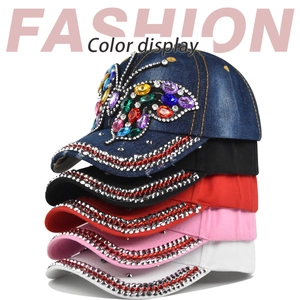 Detail showing five colors of baseball caps with rhinestones and crystal butterfly designs