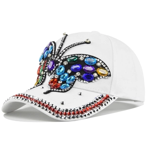 Macro detail of multi-color crystals and rhinestones butterfly on white baseball cap