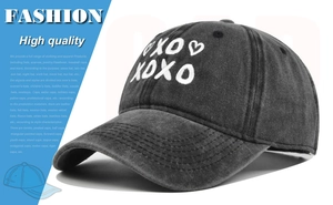 Macro detail of high quality white XOXO heart embroidery on washed dark grey baseball cap