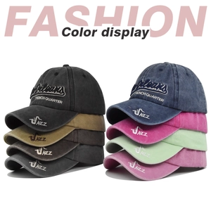 Detail view of New Orleans embroidery and vintage washed cotton baseball caps in various colors