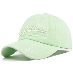 Detail of New Orleans embroidery and saxophone jazz graphic on green washed cotton cap