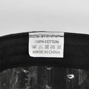 Detail of NASA baseball cap internal care label showing 100% cotton fabric and stitch quality