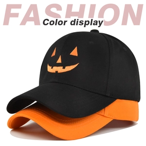 Detail view of black and orange cotton baseball caps with Halloween pumpkin embroidery