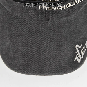 Macro shot of 3D embroidery and washed charcoal denim texture on baseball cap