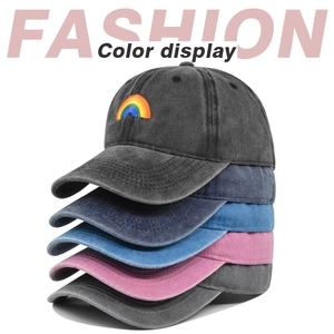Stacked vintage washed cotton baseball caps with rainbow embroidery in various colors