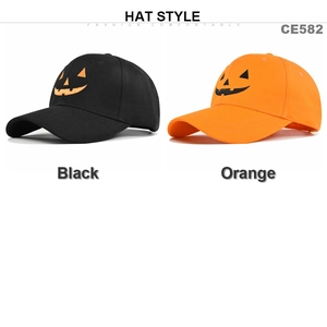 Detailed close-up of Halloween pumpkin smile embroidery on black and orange baseball caps