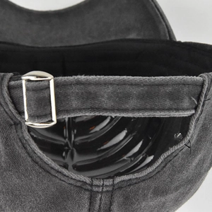 Detailed view of adjustable metal buckle on grey washed cotton baseball cap