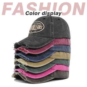 Vertical stack of New Orleans embroidered baseball caps in seven distressed vintage colors