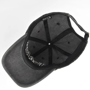 Detail of washed grey cotton baseball cap showing inner sweatband and metal buckle