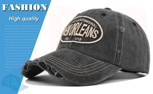 Detail of distressed dark grey New Orleans embroidery baseball cap with worn edge effect