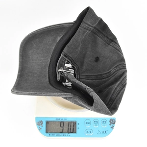 Detailed view of a lightweight grey washed cotton baseball cap weighing 91.0 grams on a scale