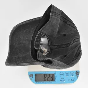 Detailed view of 82.3g washed denim baseball cap on a scale showing item weight