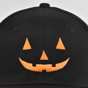 Black baseball cap with orange Halloween Jack-o'-lantern pumpkin embroidery detail