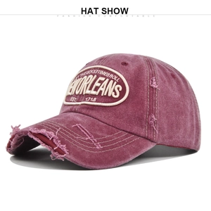 Detail of distressed pink cotton baseball cap with New Orleans embroidery and frayed edges