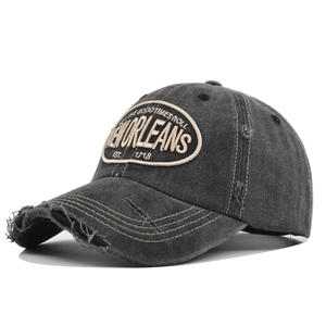 Detailed macro view of New Orleans vintage embroidery on washed cotton baseball cap