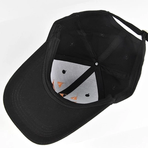 Detail view of cotton baseball cap interior featuring orange lining and adjustable metal buckle