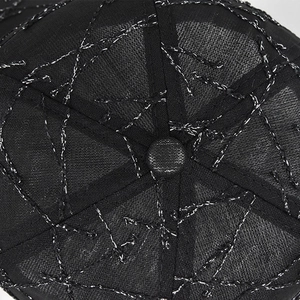 Close-up of black mesh baseball cap with silver embroidery and top button detail