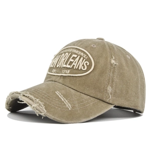 Detailed close-up of khaki New Orleans embroidery on vintage washed distressed baseball cap