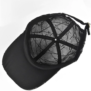 Detail of black mesh baseball cap interior with structural tape and metal buckle