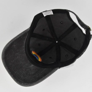 Detail view of cotton baseball cap interior showing rainbow embroidery and wash label