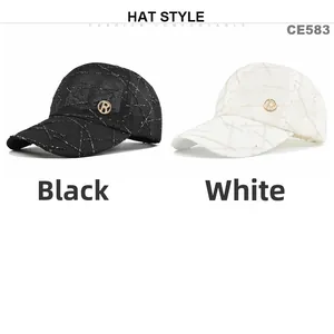 Detail view of black and white breathable baseball caps with metallic R logo emblem