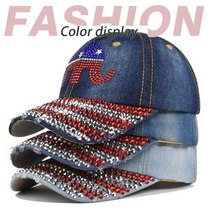 Detail of stacked denim baseball caps with rhinestone elephant pattern in various blue shades