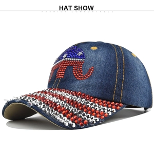 Detailed view of denim baseball cap with rhinestone elephant logo and star patterns