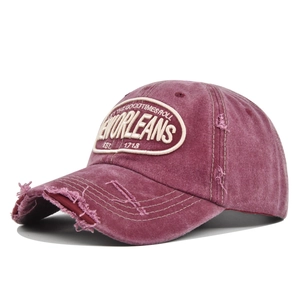 Vintage washed red baseball cap with Orleans embroidery and distressed torn brim style
