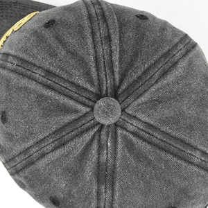 Top detail of washed charcoal cotton baseball cap with six-panel crown and metal button