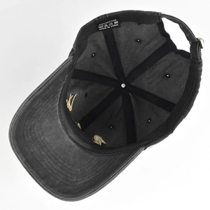 Detail view of cotton baseball cap interior with sweatband and 100% cotton wash label