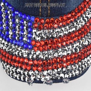 Macro shot of sparkling rhinestones flag pattern and frayed brim on denim baseball cap