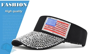 Close-up of black visor cap featuring USA flag rhinestone pattern and silver crystals