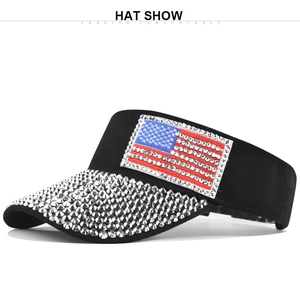 Detail of a black sun visor with rhinestone US flag patch and a sparkling sequin brim