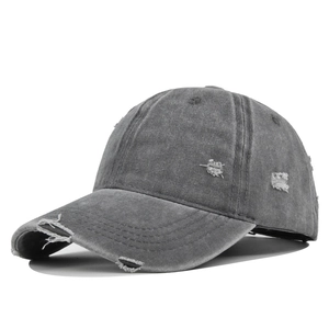 Side view of dark gray washed cotton baseball cap with vintage distressed ripped details