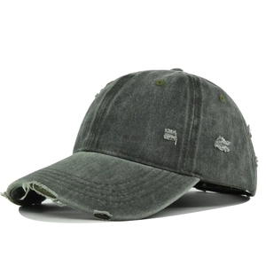 Detailed view of the distressed texture and frayed holes on a vintage washed baseball cap