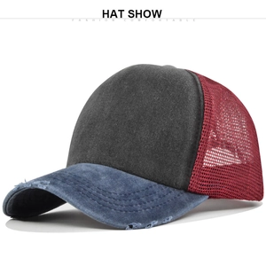 Detail view of washed cotton trucker hat showing mesh back and vintage distressed visor