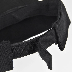 Close-up of the adjustable velcro strap on a black cotton baseball cap with stitching